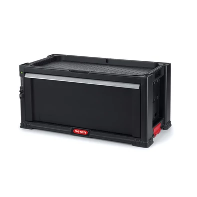 Fekete KETER 1 fiókos tároló 'Tool Chest', moduláris felépítéssel. Mély fiókja kivehető elválasztókkal rendelkezik, biztonságos zár és integrált fogantyúk segítik a könnyű szállítást. Fehér háttéren fényképezve.