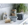 Kép 2/3 - Két világosszürke CURVER 'ESSENTIALS' kerek tál, 4L-es űrtartalommal, egy világos fürdőszobai pulton, körülöttük szappanadagolók, textil és egy vázában növény, hangulatos, otthonos környezetben.