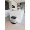 Kép 8/9 - Fémhatású, újrahasznosított műanyagból készült CURVER 'Duo Deco' pedálos szelektív szemetes, 10+18L-es kapacitással, fekete fedéllel, modern konyhai környezetben elhelyezve, praktikus használatra.